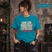 Topaz Blue Comfort Colors shirt featuring the bigger goals design with cream text, pink accents, and a casual relaxed fit.