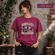 Color Berry shirt featuring the retro equality artwork with two aliens, pink hearts, stars, and cream statement text.