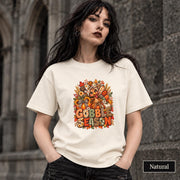 Natural Gildan 5000 tee showcasing the Thanksgiving graphic with cheerful turkey, sunflowers, patterned pumpkins, and seasonal accents.