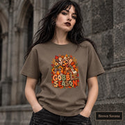 Brown Savana tee featuring the fall holiday graphic with pumpkins, plaid details, floral elements, and festive typography.