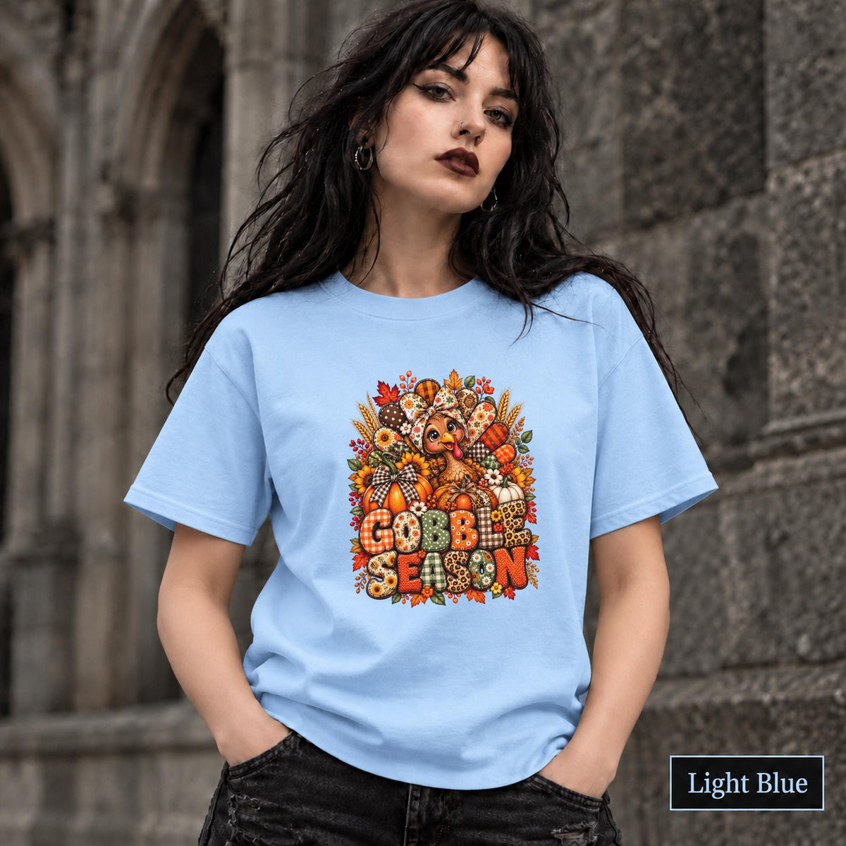 Light Blue unisex tee featuring the Thanksgiving artwork with sunflower, pumpkin, wheat, and berry details.