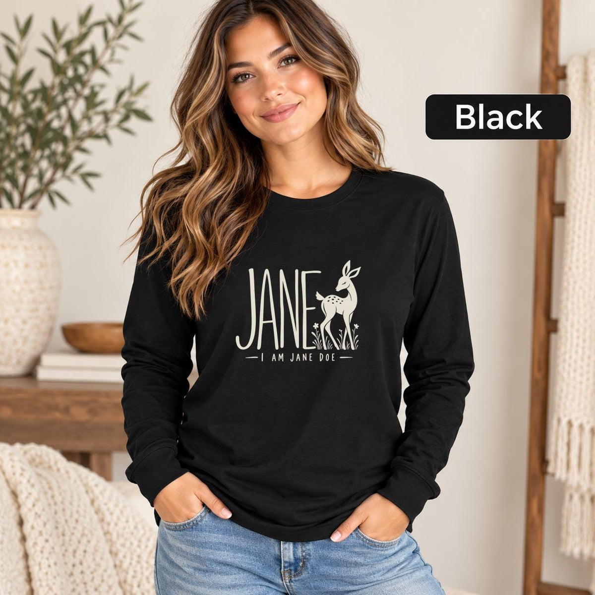Black Bella+Canvas 3501 shirt showcasing the symbolic Jane design with cream lettering and a graceful doe illustration.