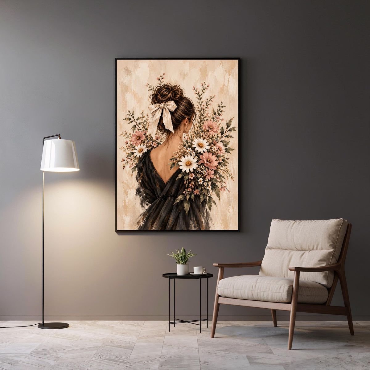 Framed vintage fashion portrait displayed above a modern accent chair and side table. Soft pink blossoms, a feminine silhouette, and a textured neutral background create an elegant reading nook accent.