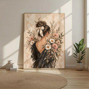 Romantic botanical woman art displayed in a bright minimalist room with warm beige furnishings. The floral portrait features an ivory ribbon, dark flowing dress, and delicate cottagecore wildflowers.