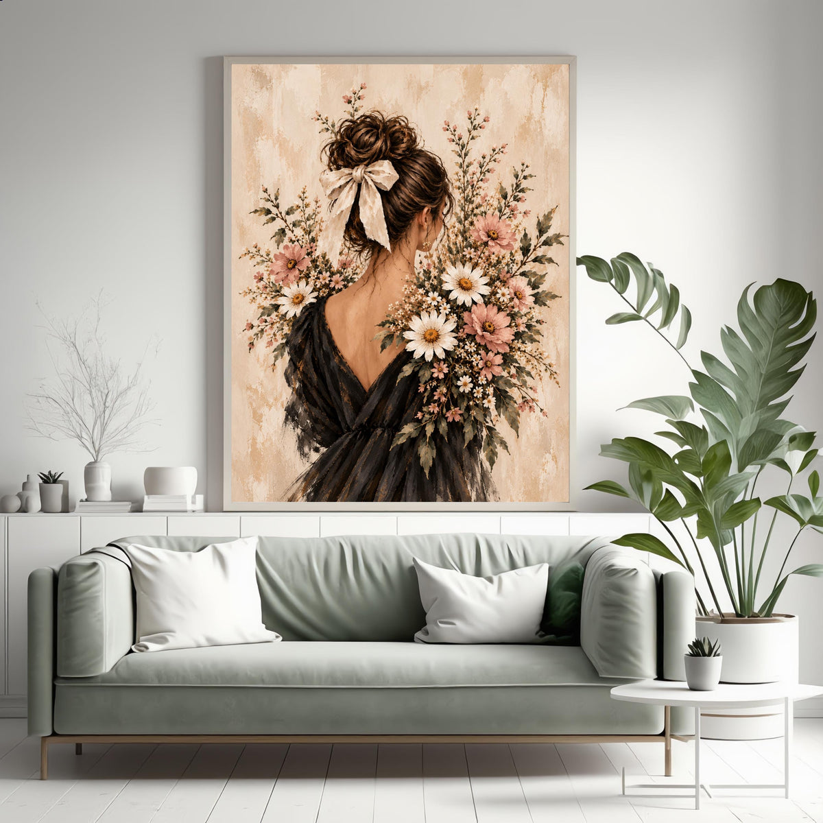 Romantic feminine art print displayed above a sage green sofa surrounded by houseplants. Blush wildflowers and an elegant black-dress portrait complement the soft, nature-inspired living room.