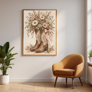 Framed Western botanical wall art displayed on a neutral wall above a warm tan accent chair. Vintage cowboy boots filled with pastel wildflowers bring soft cottagecore charm to the space.