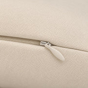 Close-up of cream Sawdust Soul pillow fabric showing the concealed beige zipper, metal zipper head, and textured polyester material.