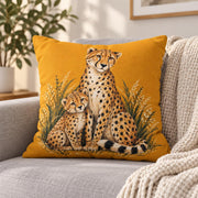 Mustard decorative pillow featuring the spotted big cat design with earthy foliage accents on a light-colored couch.