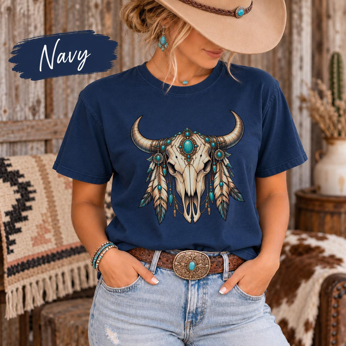 Navy tee showcasing the ornate Western skull graphic with feather details and turquoise-inspired stones.