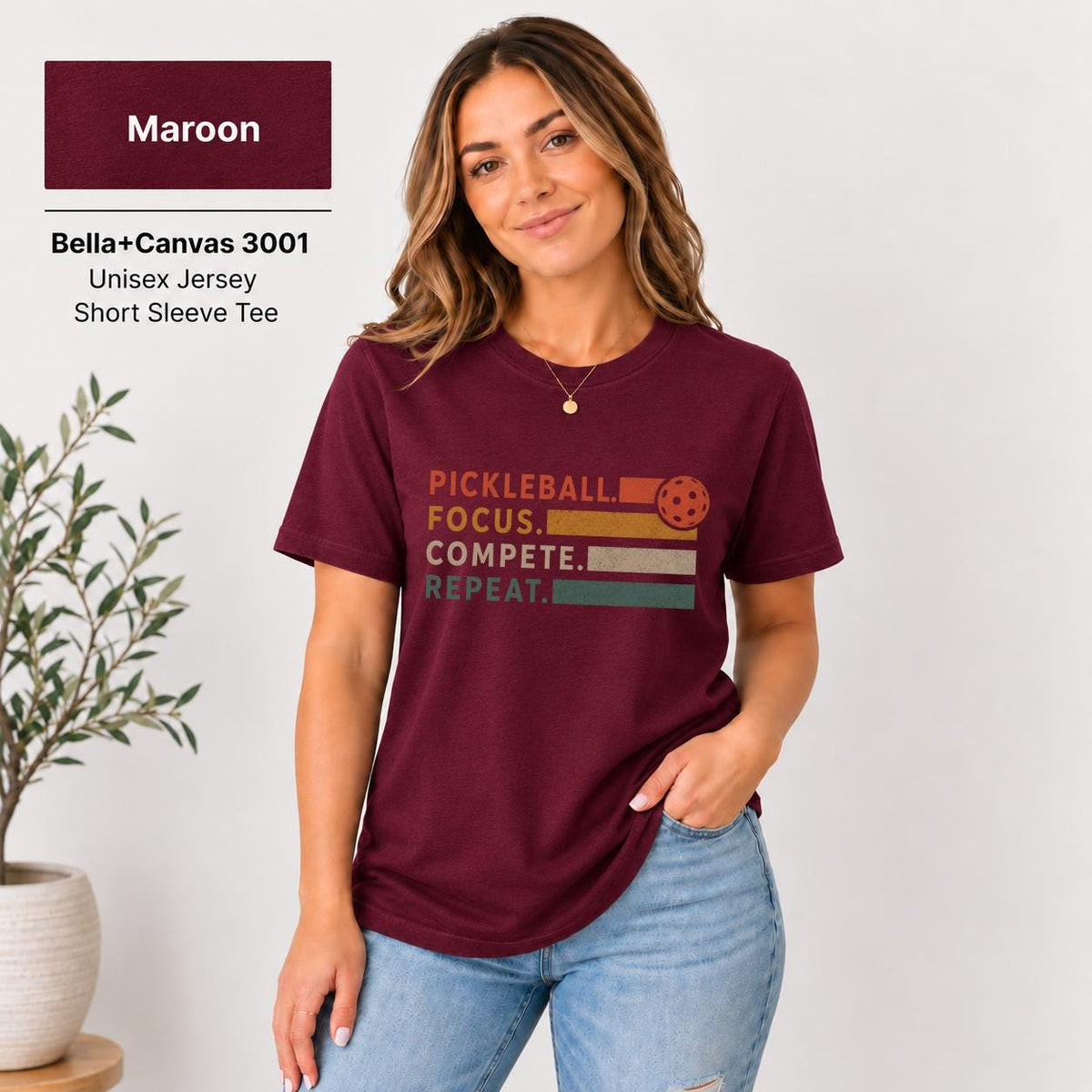 Maroon T-shirt showcasing the minimalist text design with contrasting orange and red lettering.
