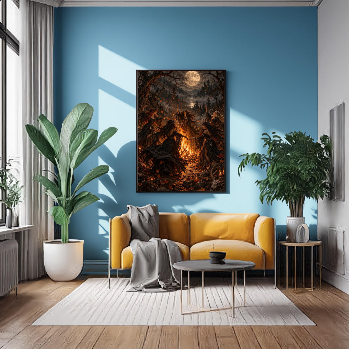 Framed witchcore poster displayed above a mustard-yellow sofa against a rich blue accent wall. Five women in flowing black gowns gather around a glowing fire in an enchanted moonlit forest.