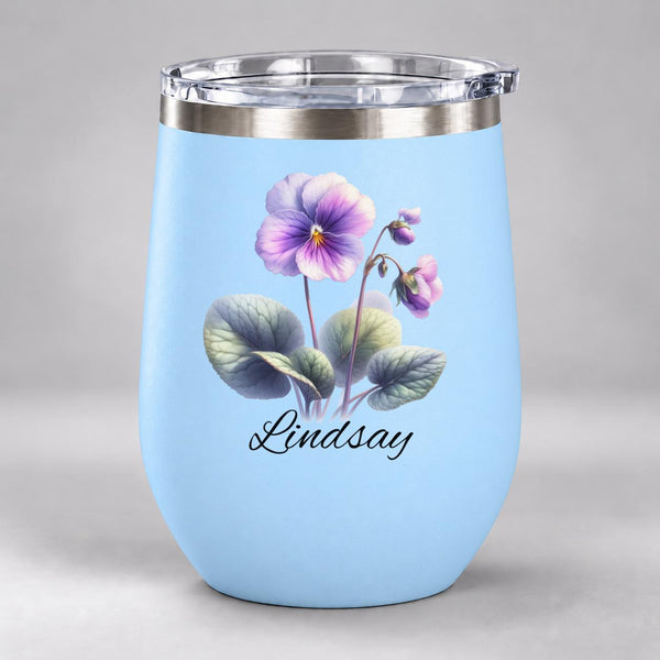 Light blue 12oz personalized wine tumbler featuring a watercolor violet birth flower and the custom name “Lindsay” in black script.
