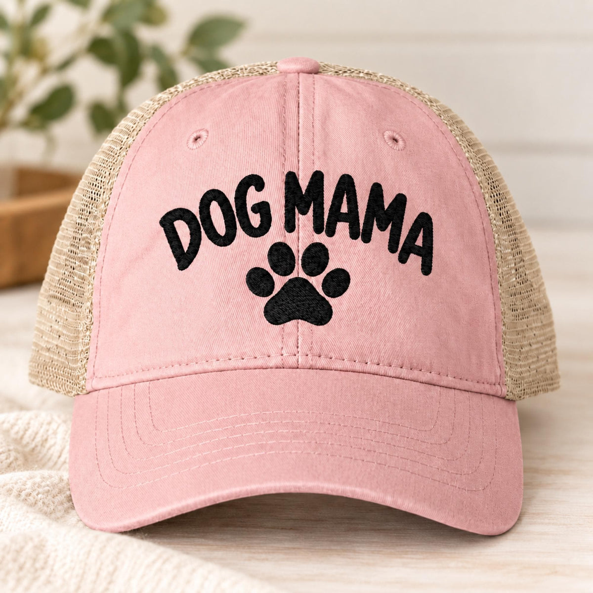 Dusty pink cap showcasing the black Dog Mama embroidery with paw print and casual washed finish.