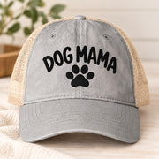 Light grey women’s mesh-back hat featuring the Dog Mama design with black embroidered lettering and paw graphic.