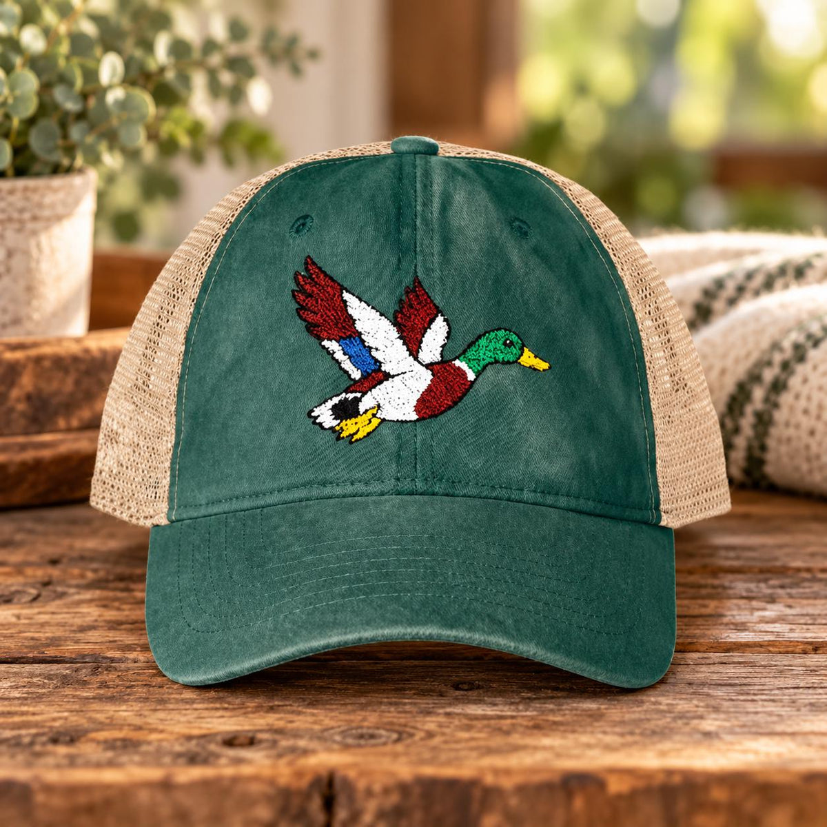 Jade green ponytail cap displaying the colorful embroidered duck design with washed fabric and tan mesh panels.