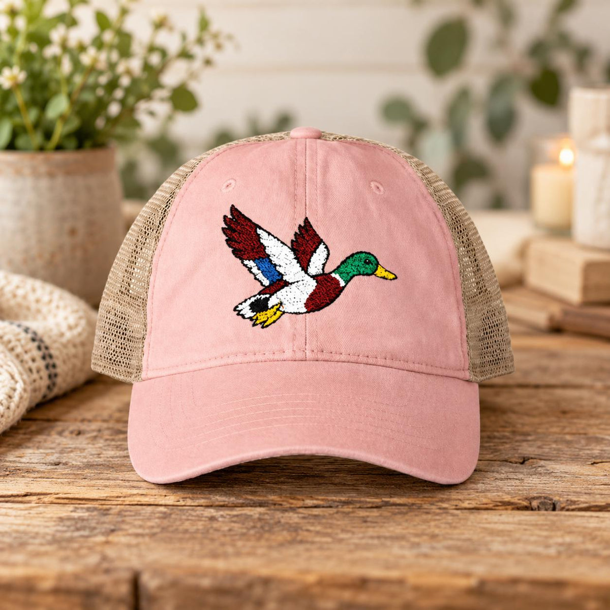 Dusty pink cap showcasing the embroidered mallard design with tan mesh back and curved visor.