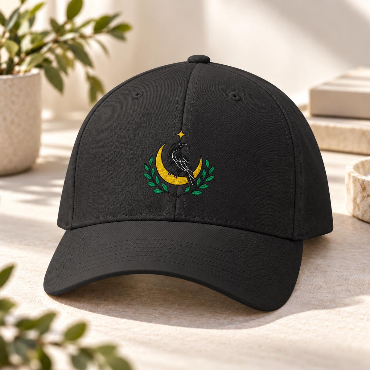 Black structured cap featuring the embroidered raven, crescent moon, and green foliage design for a gothic celestial look.