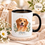 Personalized white ceramic dog mug featuring a watercolor-style golden retriever portrait, floral greenery, and the custom name “Bella” with a black handle and interior.