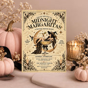 Editable Midnight Margaritas Halloween invitation displayed on a dusty pink background with pale pumpkins, dried flowers, and candlelight. The vintage witch illustration features Gothic lettering, celestial details, and a decorative cream background.