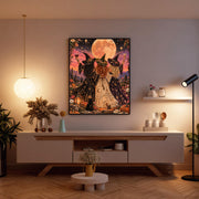Moonlit witch poster displayed above a wooden console in a softly lit living room. The artwork combines a glowing peach full moon, sunset colours, blooming wildflowers, and three elegantly dressed witches.