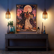 Celestial fantasy poster displayed above a dark blue console table between two glowing wall sconces. The whimsical artwork features three women in pointed witch hats and flowing gowns celebrating beneath an enormous full moon.
