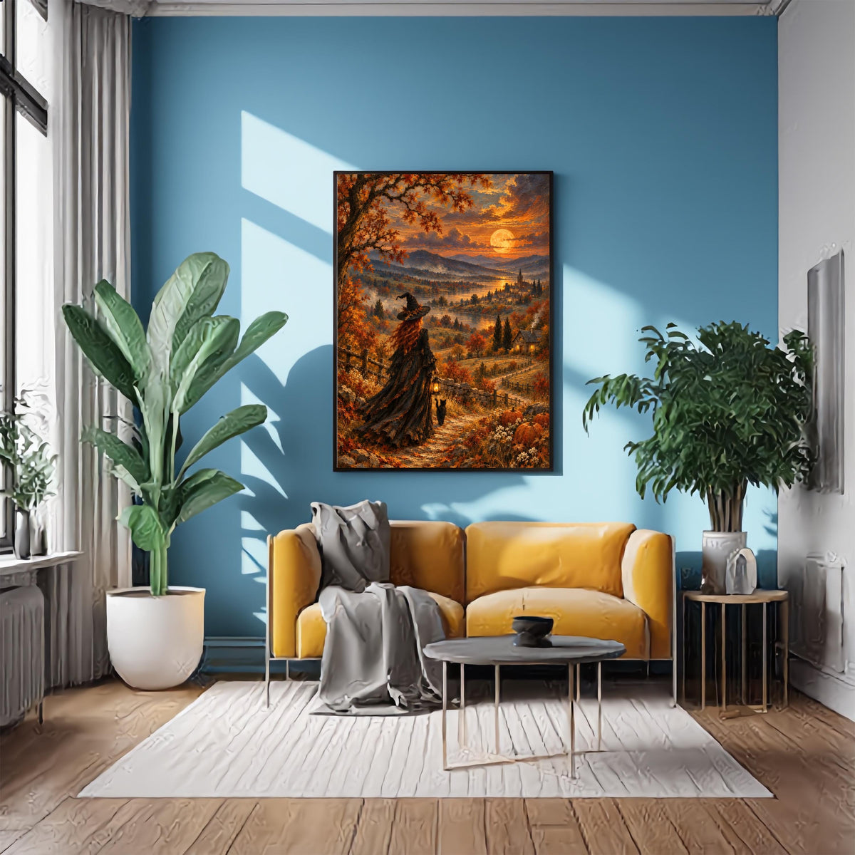 Mystical witch landscape painting displayed on a textured grey wall beside a tan leather chair. The autumn artwork features a witch walking along a winding path beneath a glowing moon, surrounded by orange foliage and a distant village.