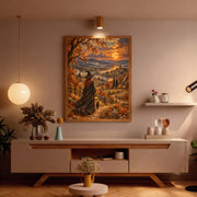 Framed Gothic autumn artwork displayed above a cream console table with dried floral decorations. The painting features a witch walking with her black cat through a glowing fall landscape beneath a golden moon.