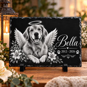 Personalized pet memorial slate featuring a black-and-white dog portrait with angel wings, halo, floral accents, custom name Bella, memorial dates, and display stand.