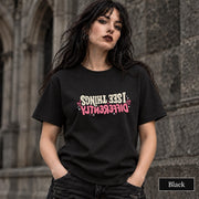 Black unisex T-shirt featuring the “Same Girl, Bigger Goals, Stronger Coffee, Less Bullshit Than Before” motivational graphic in cream and pink lettering.