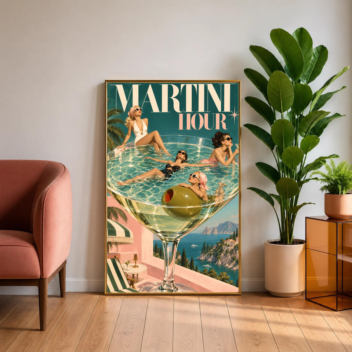 Vintage martini poster resting on a light wooden cabinet beside a tall leafy houseplant and blush accent chair. The artwork features stylish women in retro swimsuits, turquoise water, a giant green olive, and Mediterranean scenery.