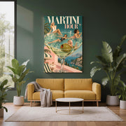 Funky maximalist wall art displayed above a mustard-yellow sofa against a dark green accent wall. The Martini Hour print features glamorous women in vintage swimwear inside a giant martini glass with an Italian coastal view.