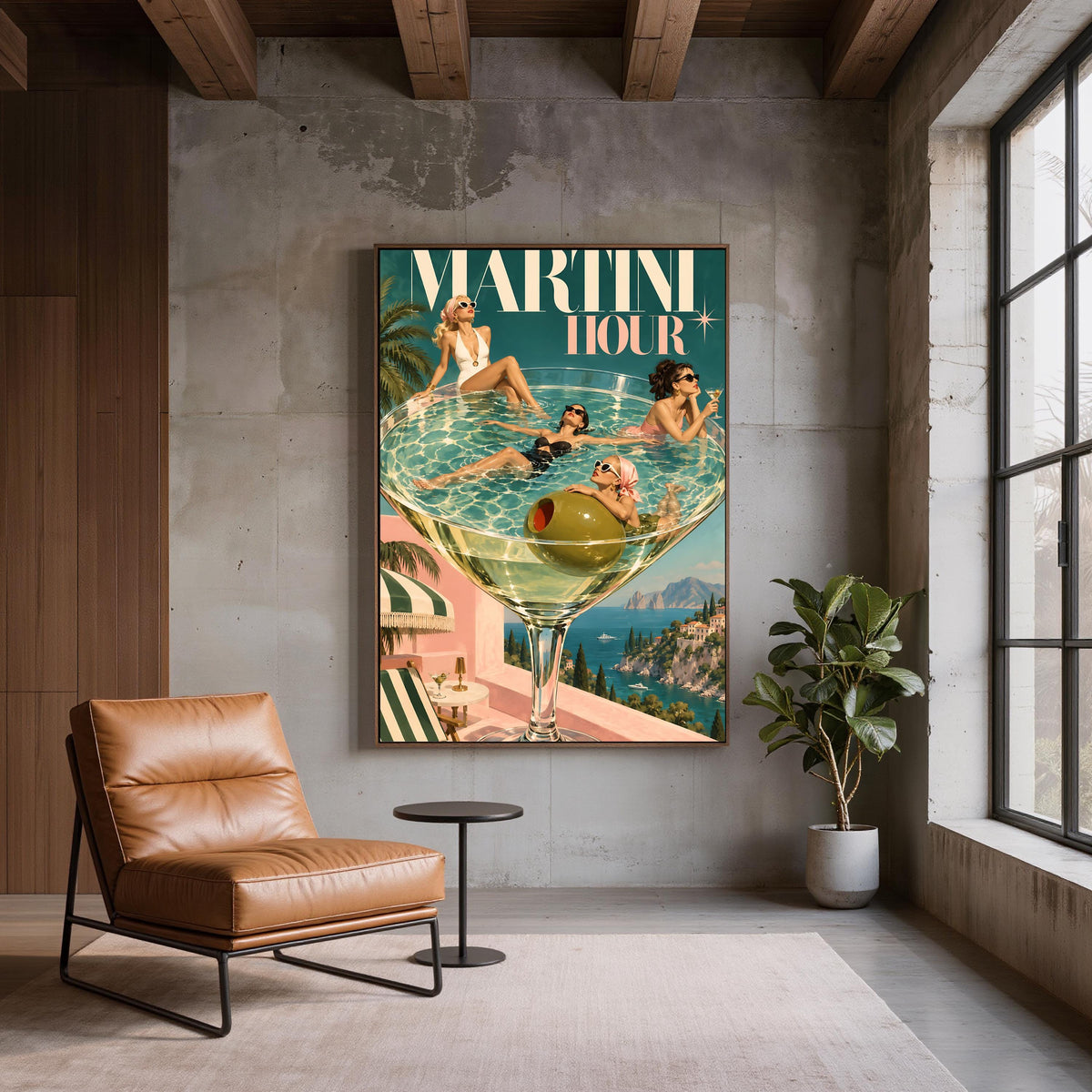 Retro cocktail poster displayed on a textured grey wall beside a brown leather accent chair. The artwork combines mid-century glamour, a surreal oversized martini glass, and a scenic Mediterranean coastline.