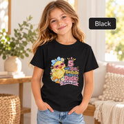 Black Bella+Canvas youth shirt featuring the colorful duckling birthday design with pink, blue, and yellow accents.