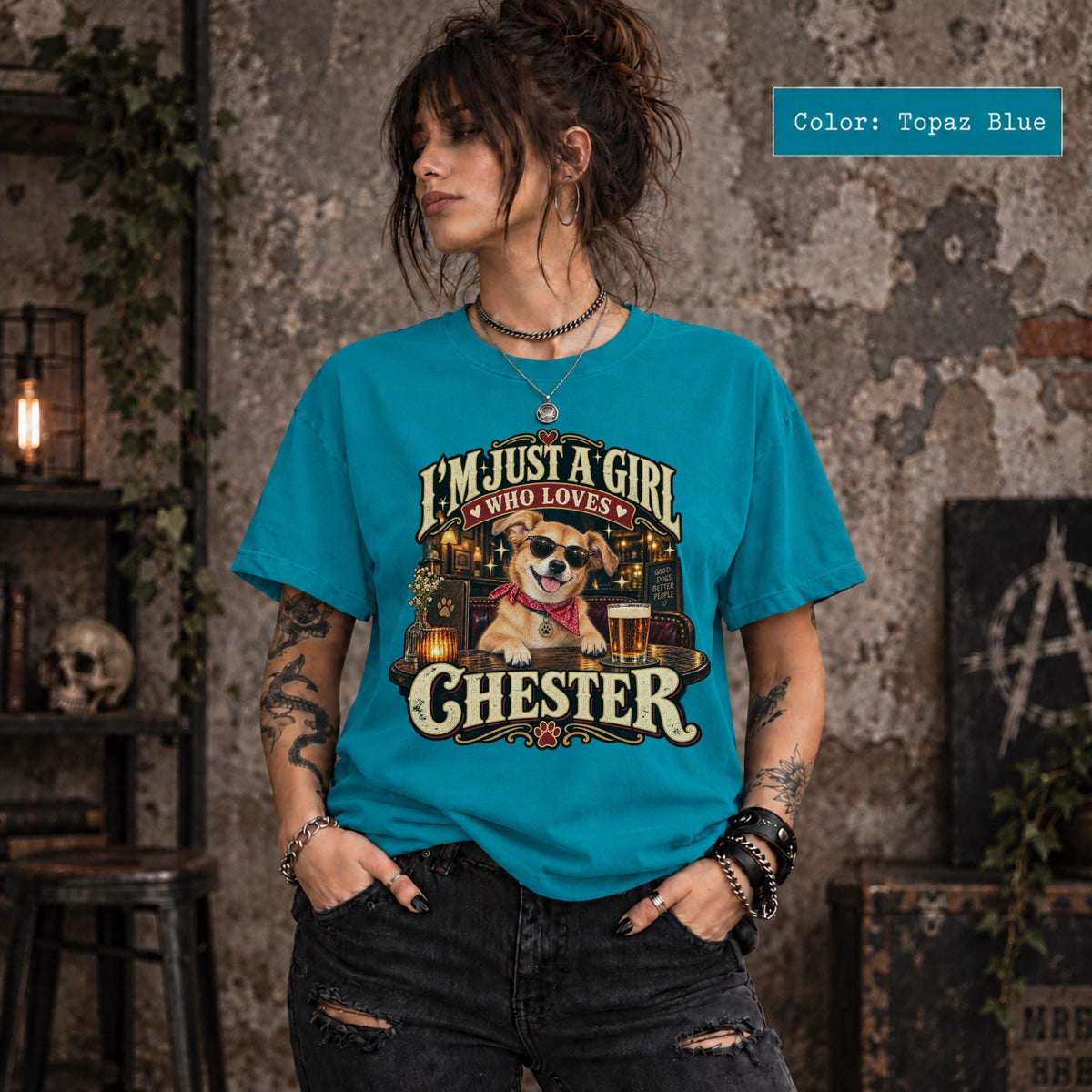Woman wearing a topaz blue personalized dog photo shirt displaying the custom Chester design with golden lettering, retro bar scene, and a playful pet portrait.