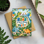 Personalized dinosaur birthday invitation displayed on a light tabletop with tropical greenery, featuring playful dinosaurs, party hats, jungle decorations and colorful birthday details.