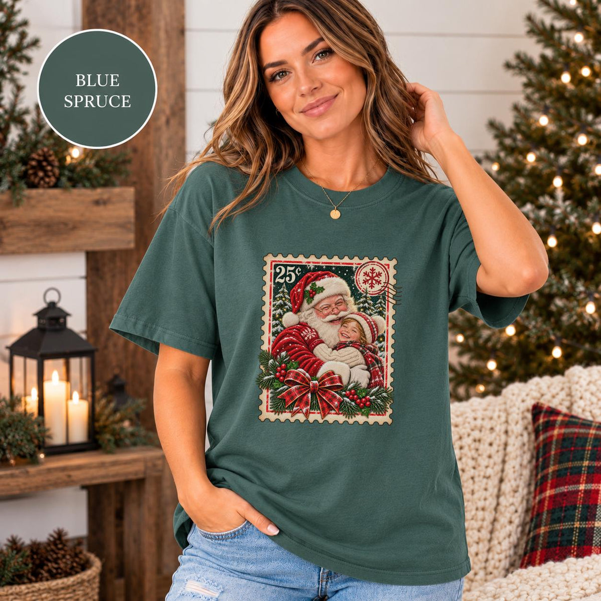 Blue Spruce Comfort Colors tee showing the custom child Christmas design with Santa, evergreen trees, festive greenery, and a nostalgic postage-stamp border.