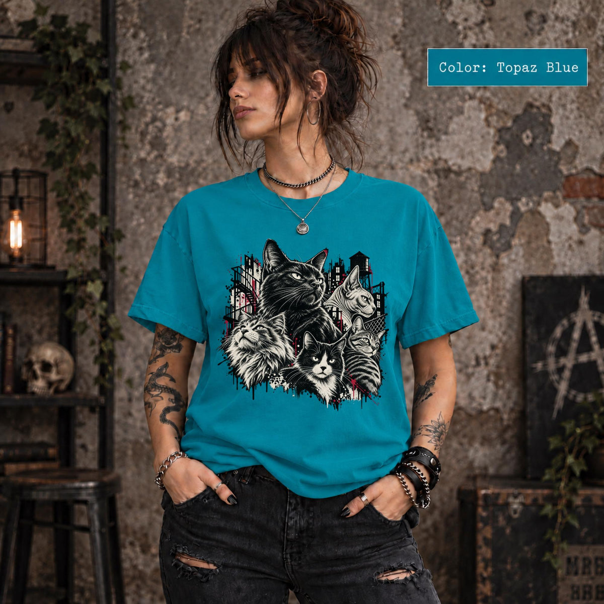 Topaz Blue Comfort Colors tee showing the gothic multi-cat artwork with bold contrast and alternative styling.