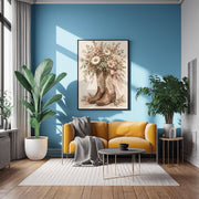 Feminine Western wall art displayed above a mustard yellow sofa against a blue accent wall. The framed print features floral cowboy boots, pink gingham ribbon, and romantic wildflowers in soft neutral colours.