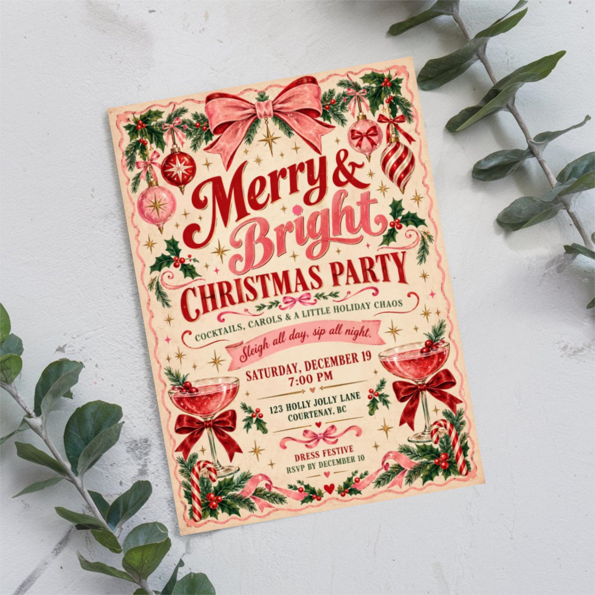 Christmas game night invitation resting on a soft neutral background with eucalyptus branches. Red and green vintage lettering and holiday illustrations create a cheerful seasonal design.