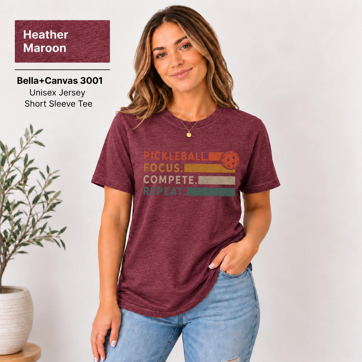 T-shirt displaying the same chest graphic in a casual unisex fit.

Heatehr Maroon shirt featuring the warm-toned statement artwork for a bold