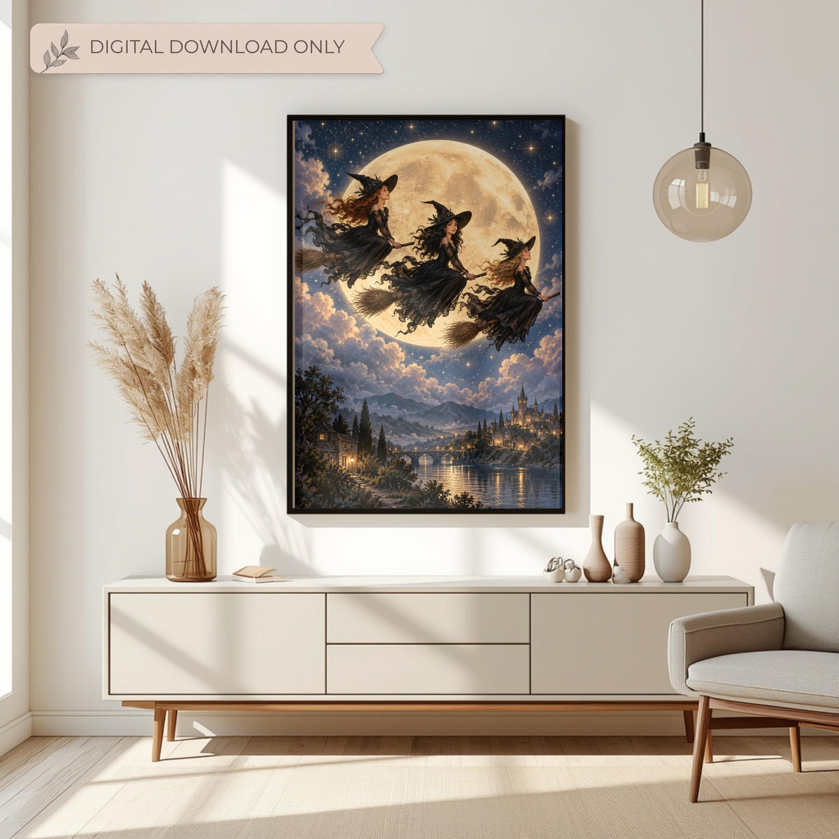 Framed witchy bedroom poster displayed above a cream console table with dried flowers and neutral decorations. The romantic fantasy artwork features three flying witches against a luminous golden moon.