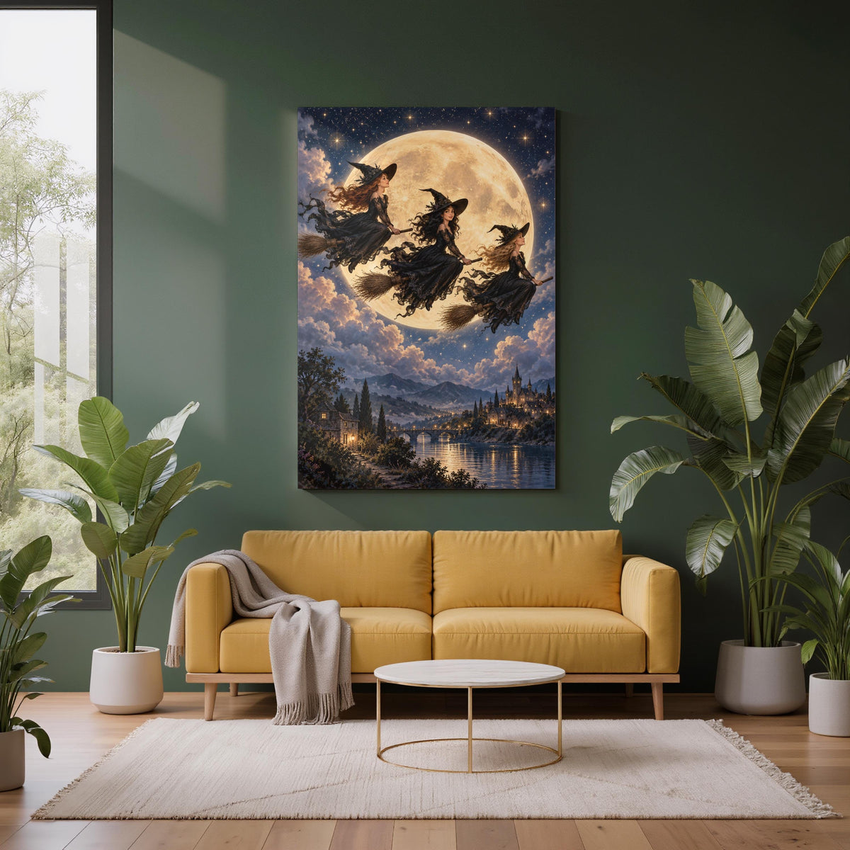 Celestial fantasy wall art displayed above a mustard sofa against a deep green wall with tropical plants. Three elegant witches fly across a glowing full moon above a mystical landscape.