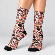 Retro cat patterned crew socks modeled against a clean white studio background. Detailed design features adorable cats wearing sunglasses, pink hair accessories, leopard print, hearts, coffee cups, and contrasting black toes.