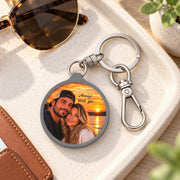 Custom photo keychain styled beside sunglasses and accessories, featuring a couple portrait printed on the round pendant.