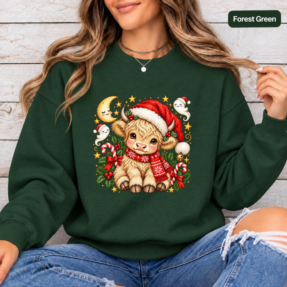 1. Forest Green Gildan 18000 crewneck displaying the cute holiday cow artwork with red, cream, and gold accents for a classic Christmas look.