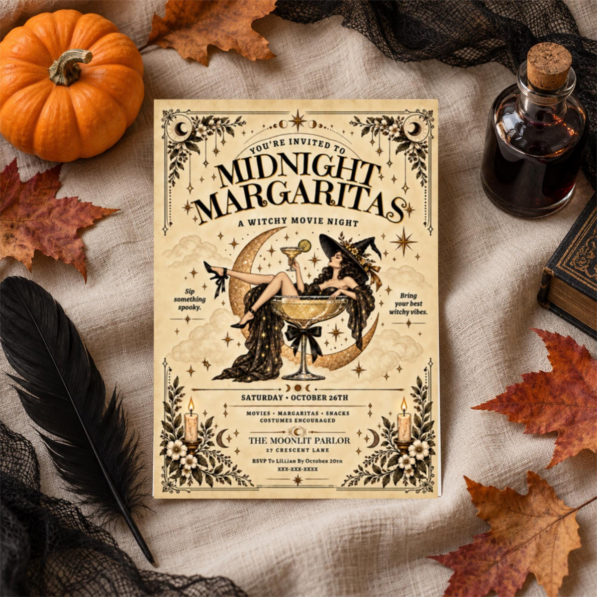 Editable Halloween invitation resting on soft cream fabric with orange pumpkins, dried autumn leaves, black feathers, and a dark decorative bottle. The Midnight Margaritas template features Gothic lettering and botanical illustrations.