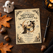 Vintage Midnight Margaritas invitation displayed on a dark wooden surface with a white ghost ornament, autumn leaves, and Halloween accessories. The witch-themed artwork features celestial stars, a crescent moon, and antique-style typography.