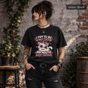 Black Comfort Colors 1717 T-shirt featuring a sassy white cat in sunglasses with pink accents and the quote “I Try to Be a Nice Person, But Sometimes My Mouth Doesn’t Cooperate.”