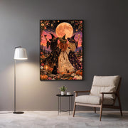 Framed witchy boho wall art displayed above a grey accent chair and side table. The artwork features three magical women celebrating beneath a peach-coloured moon, surrounded by stars and wildflowers.