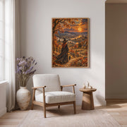 Framed vintage witchcore wall art displayed above a wooden dining table in a warm contemporary interior. The magical landscape features a moonlit river, autumn trees, black cat, and charming countryside cottages.